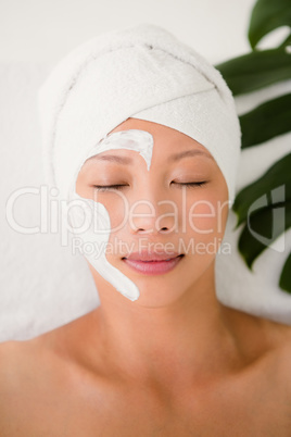 Attractive woman with cream treatment