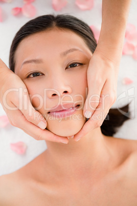 Attractive young woman receiving facial massage