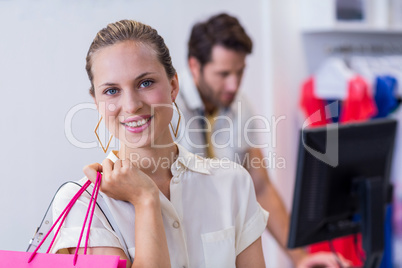 Smiling woman standing in front of till