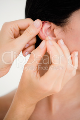 Woman holding a needle in an acupuncture therapy