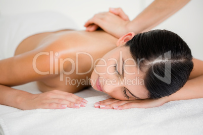 Pretty brunette enjoying a massage