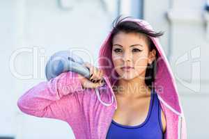 Athletic woman holding kettlebell
