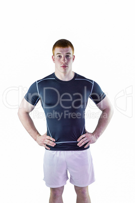 Muscular rugby player with hands on hips