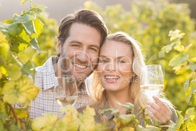 Young happy couple holding glasses of wine