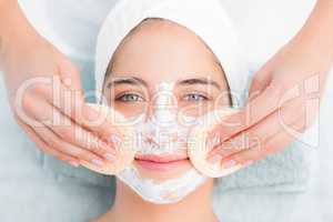 Hands cleaning woman face with cotton swabs