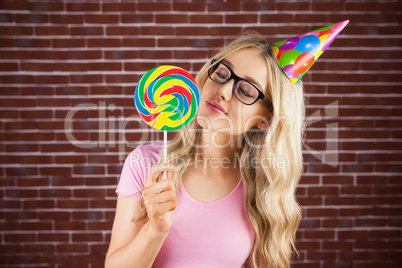 A beautiful hipster holding a giant lollipop