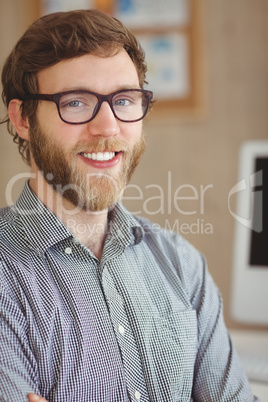 Happy hipster sitting at his desk