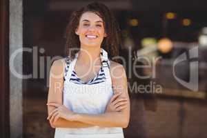 Smiling waitress with arms crossed