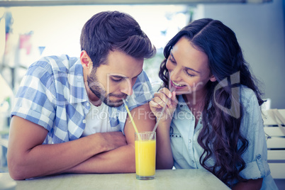 Cute couple drinking an orange juice together