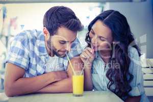 Cute couple drinking an orange juice together