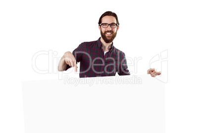 Handsome hipster showing large poster