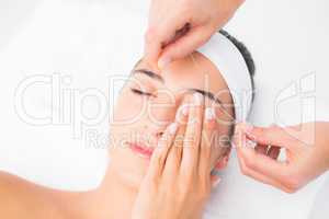 Hands threading beautiful womans upper eyes