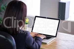 Businesswoman working at her desk on laptop