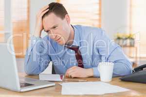 Stressed businessman working at his desk