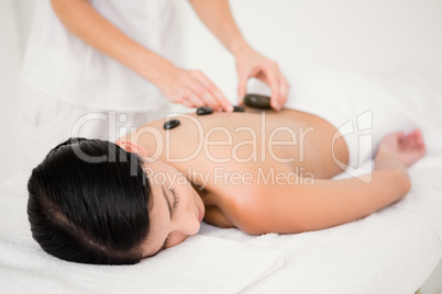 Pretty woman receiving a hot stone massage