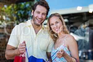 Smiling couple holding shopping bags