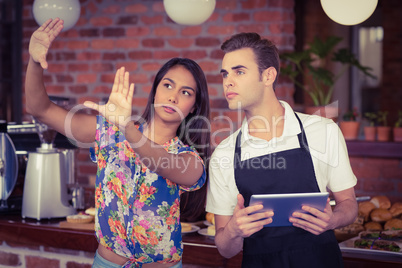 Pretty customer explaining to waiter