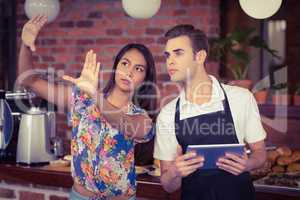 Pretty customer explaining to waiter