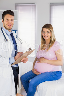 Portrait of smiling doctor and his pregnant patient