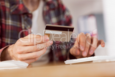 Hipster businessman shopping online with card