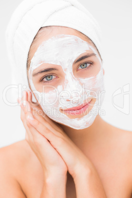 Attractive woman having white cream on her face