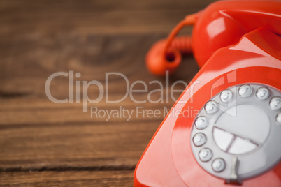 Red telephone on wooden table