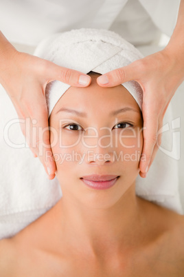 Attractive young woman receiving forehead massage