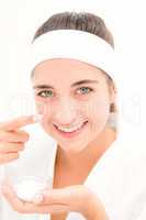 Beautiful smiling woman mid section of woman applying cream