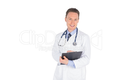 Smiling doctor writing on a clipboard