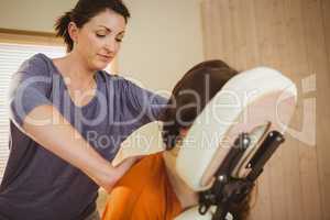 Young woman getting massage in chair