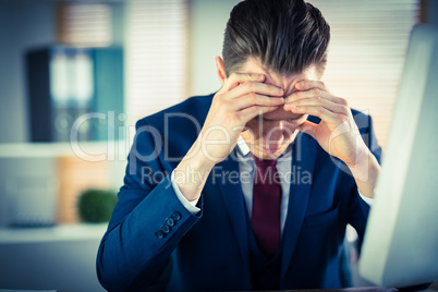 Worried businessman working at his desk