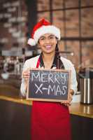 Pretty waitress with a chalkboard merry x-mas