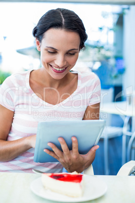 Happy woman enjoys using her tablet