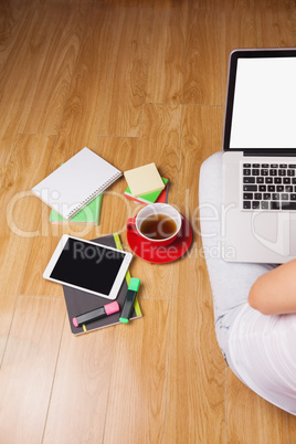 Overhead shot of laptop, tablet, coffee and headphones