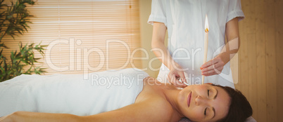 Young woman getting an ear candling treatment