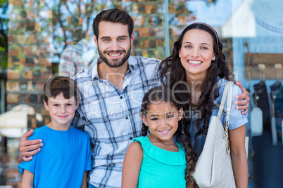 Portrait of a happy family having fun in the mall