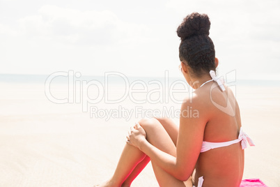 Slim woman sunbathing on towel