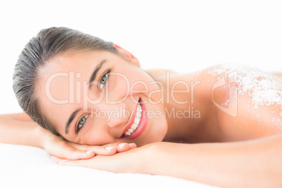 Beautiful brunette enjoying a salt scrub treatment