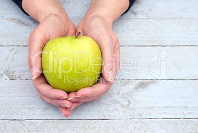 Female hands with fresh Apple