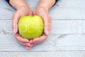 Female hands with fresh Apple