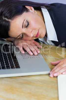 Businesswoman taking a nap on her desk