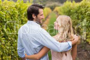 Young happy couple having an arm around each other and smiling