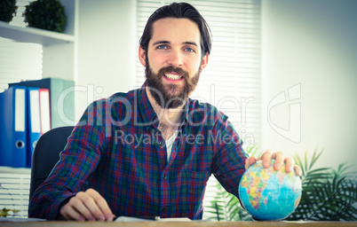 Hipster businessman with a globe