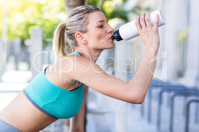 A beautiful woman sitting and drinking