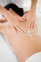Woman receiving a salt scrub massage
