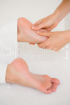 Close-up of a woman receiving foot massage