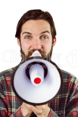 Handsome hipster shouting through megaphone