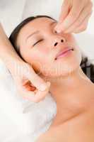 Hands threading beautiful womans face