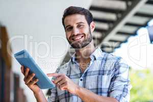 Hipster man using tablet computer in the city