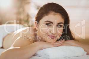 Young woman lying on massage table